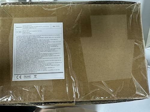 Cardboard box with a label containing text and symbols.