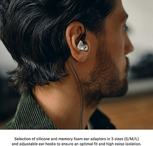 Man wearing in-ear headphones with ear adaptors.