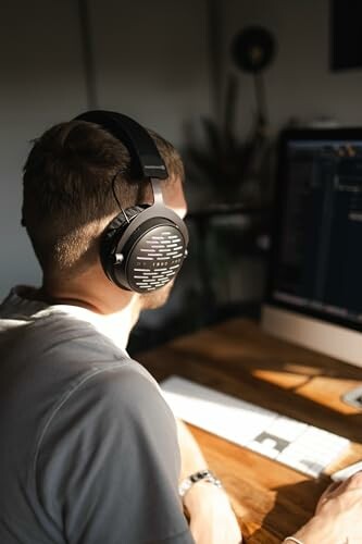 Person wearing headphones working on a computer